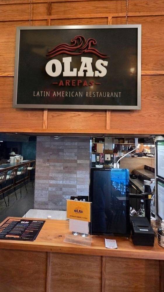 Olas Arepas sign and counter